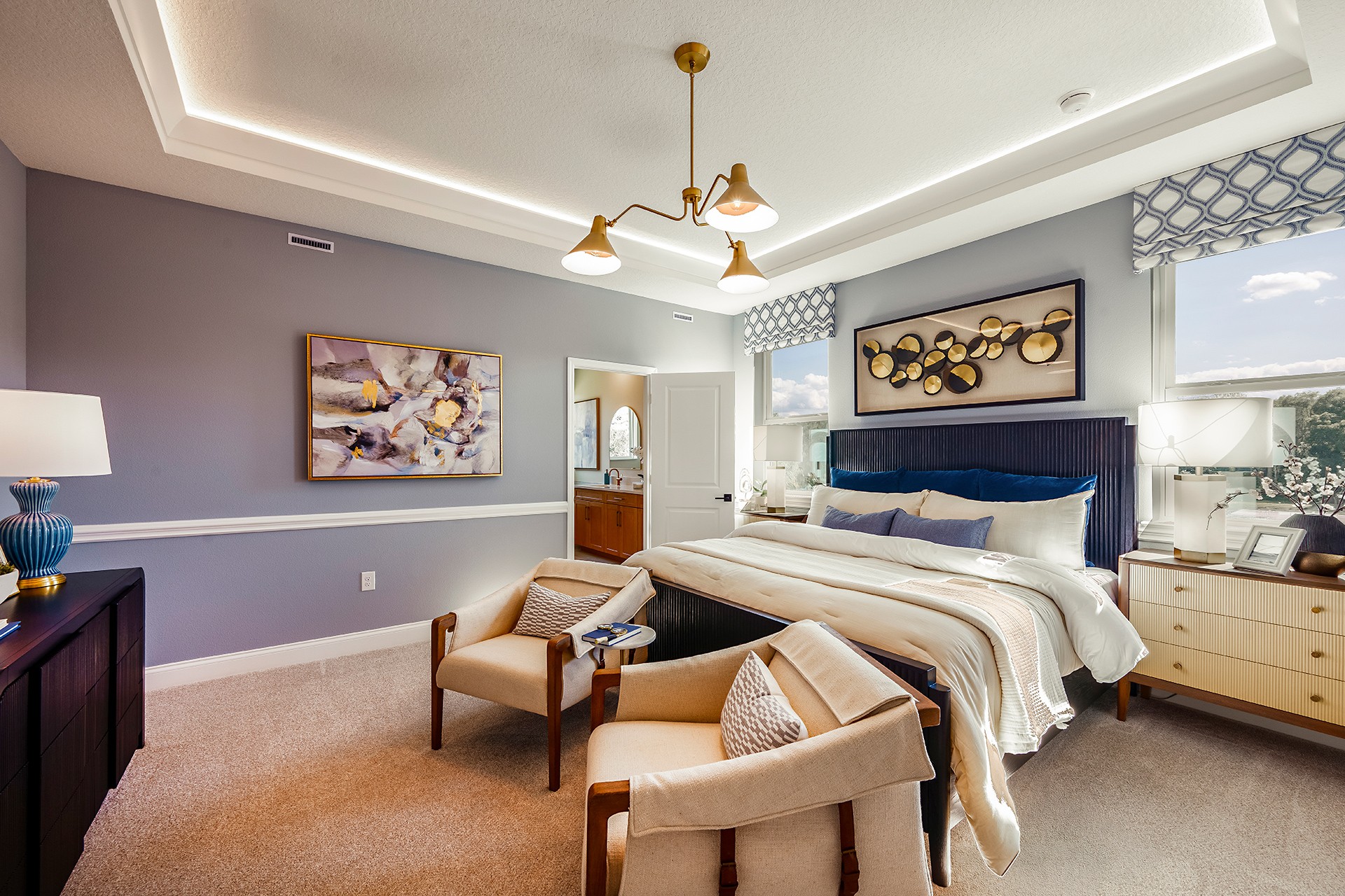 room with carpet throughout, tray ceilings and large windows.