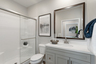 bathroom with white countertops and grey cabinets