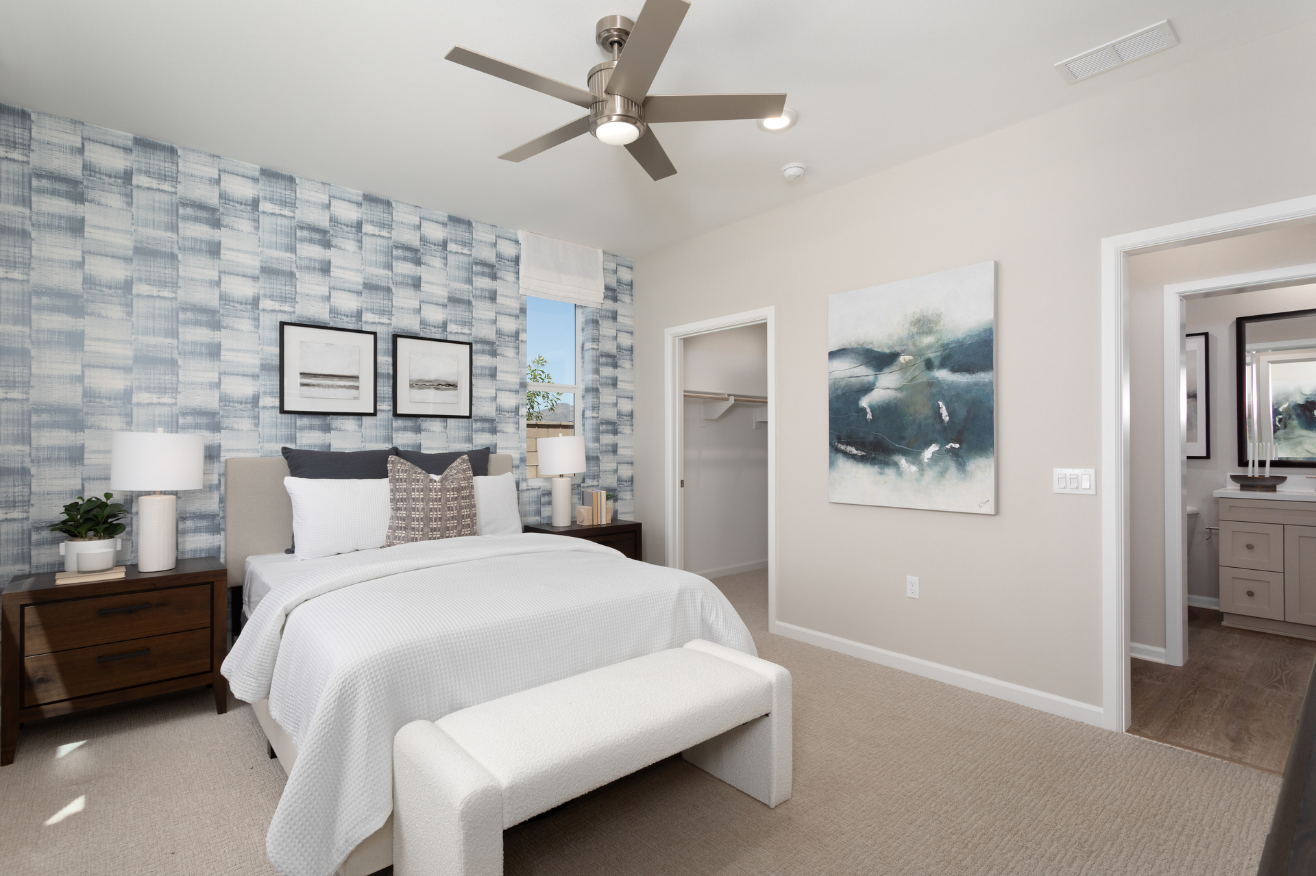 bedroom with neutral floors and accent wall