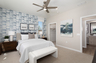 bedroom with neutral floors and accent wall