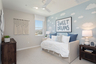 bedroom with neutral floors and large window