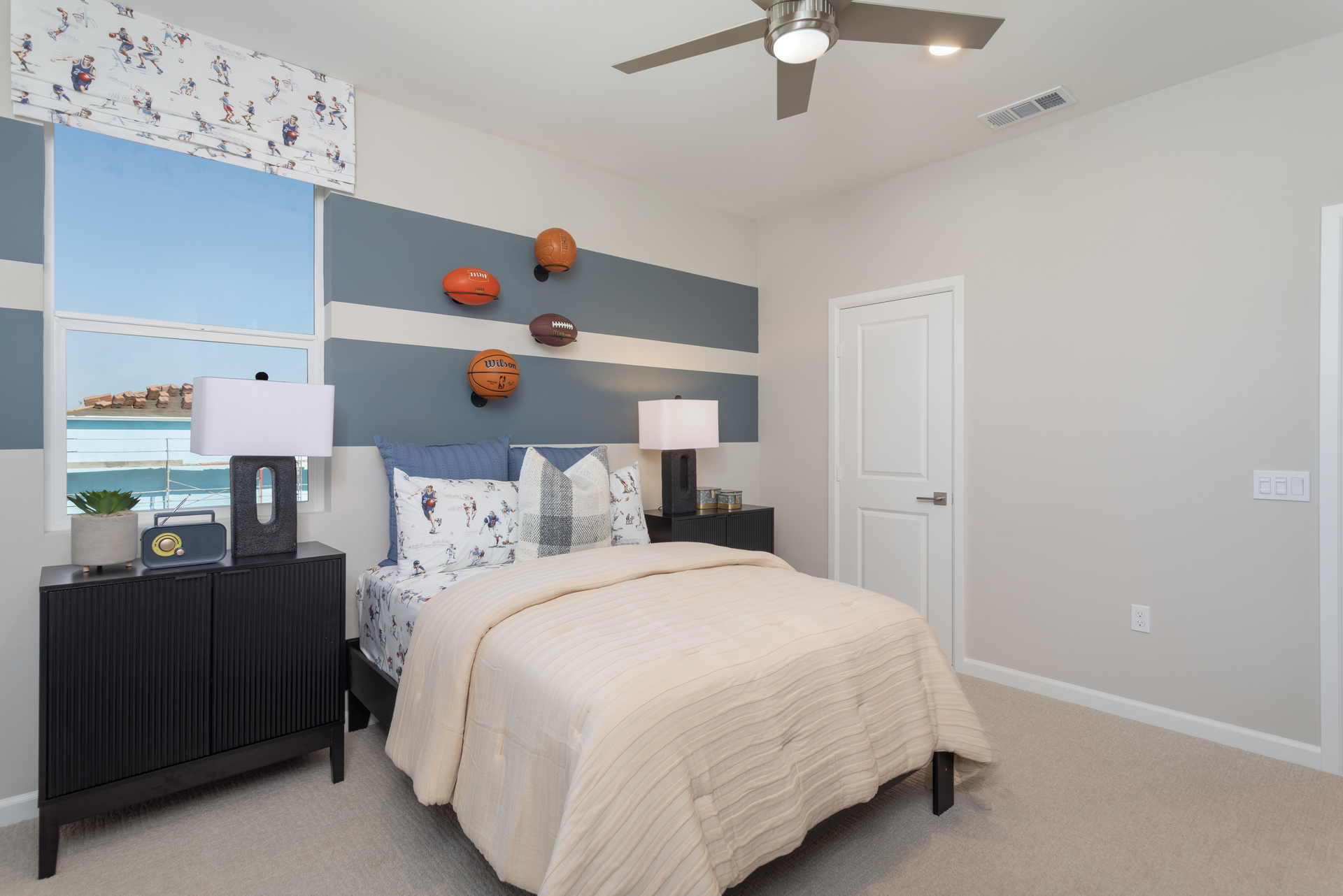 bedroom with accent wall and large window