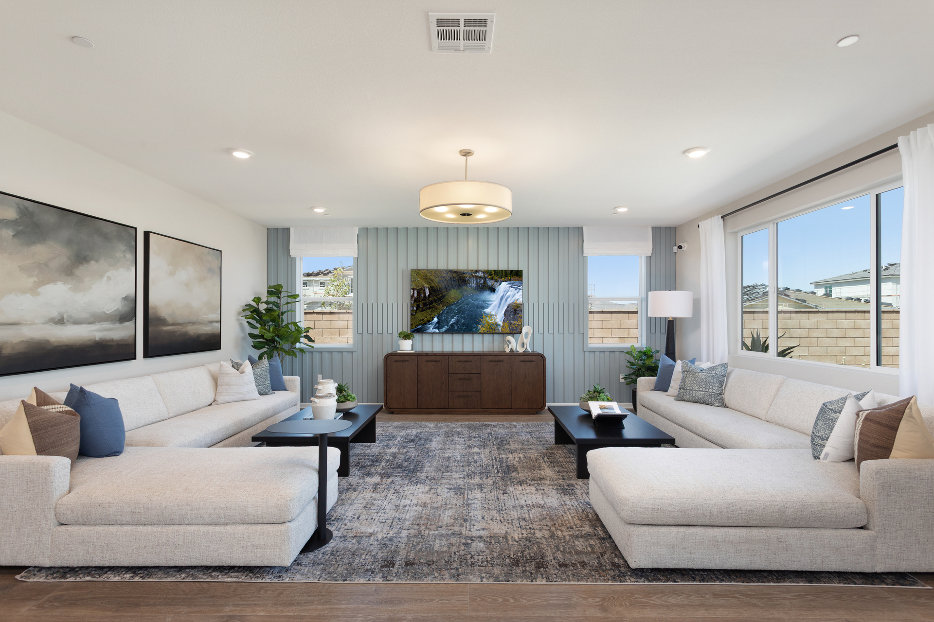 great room with large windows and neutral floors