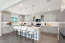 kitchen with neutral floors and large island