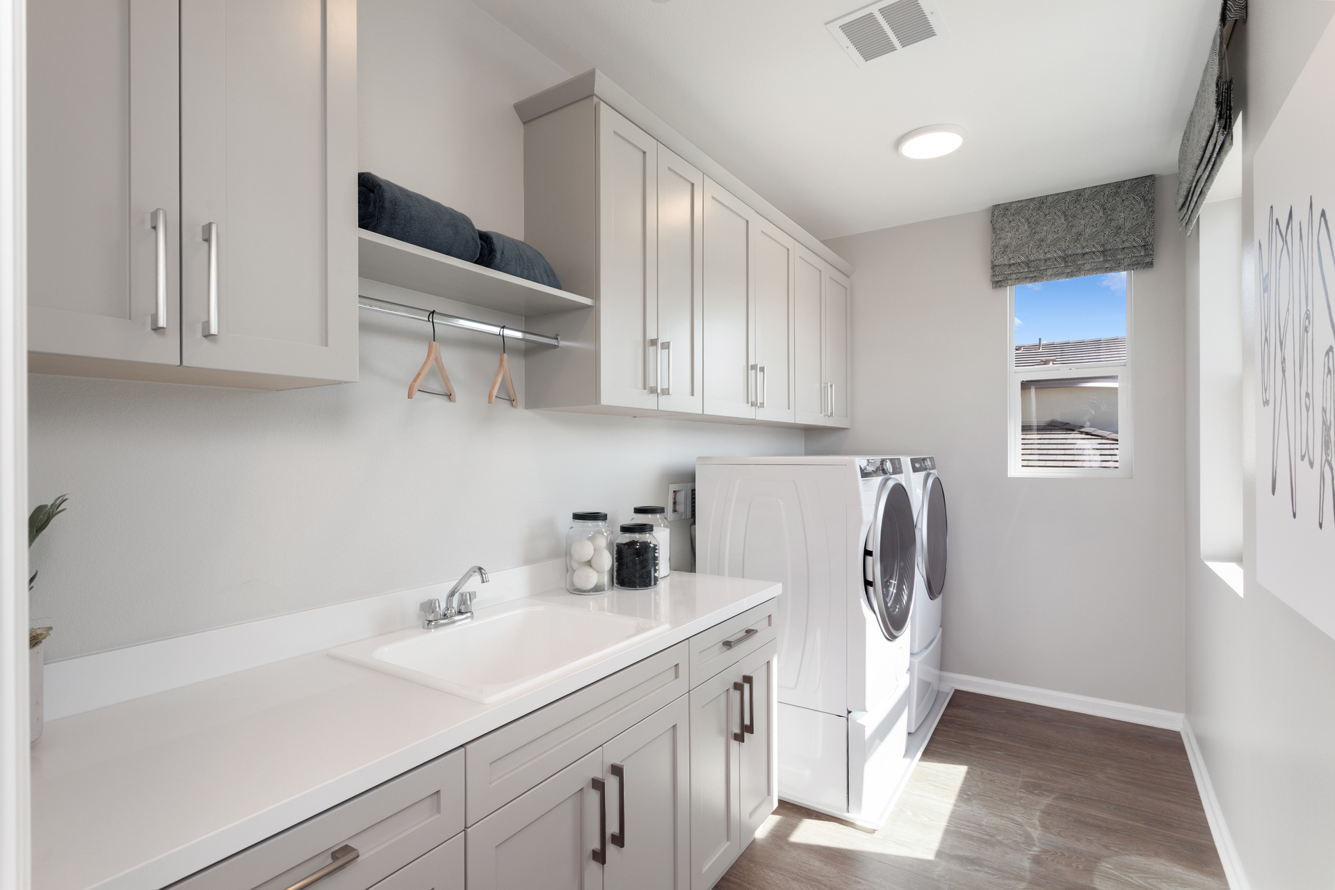 laundry room with large windows and storage
