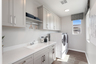laundry room with large windows and storage