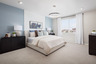 primary bedroom with neutral carpet and large window