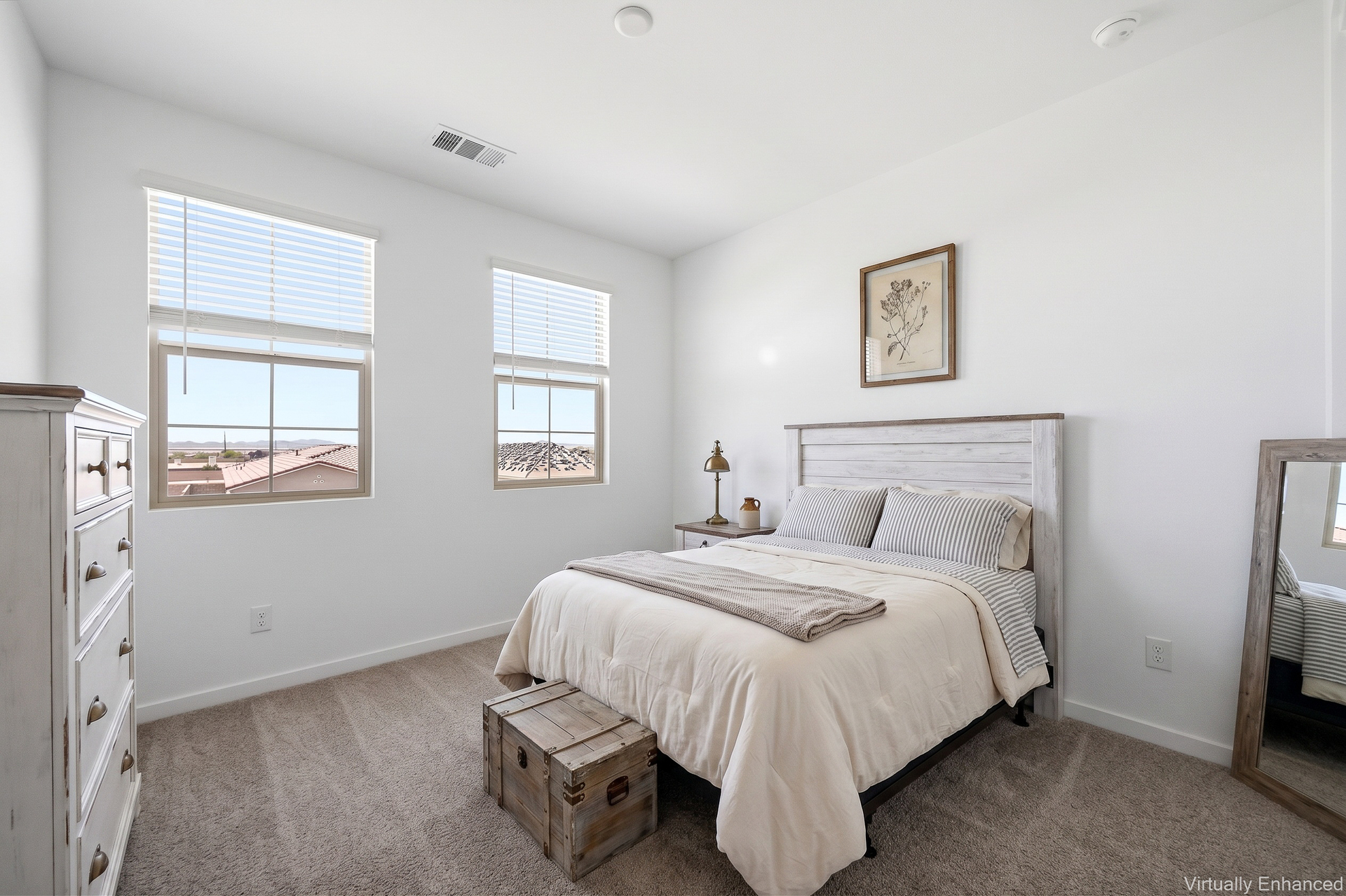 bedroom with white wooden bedframe, antique white dresser, and antique white wooden nightstand