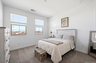 bedroom with white wooden bedframe, antique white dresser, and antique white wooden nightstand