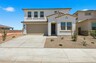 two-story single-family home with desert landscaping and concrete driveway