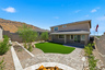 spacious backyard with pavers, artificial grass, and mountain views