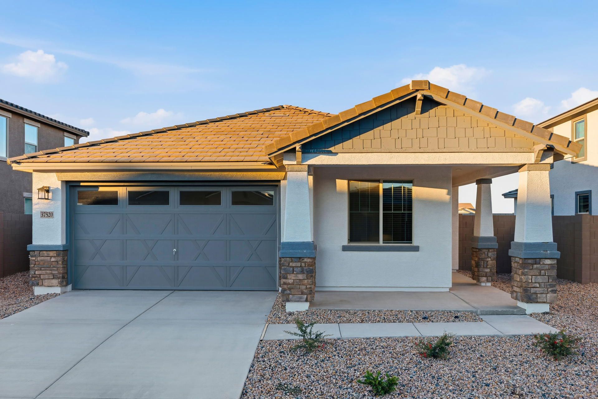 single-story home with desert landscaping and concrete driveway