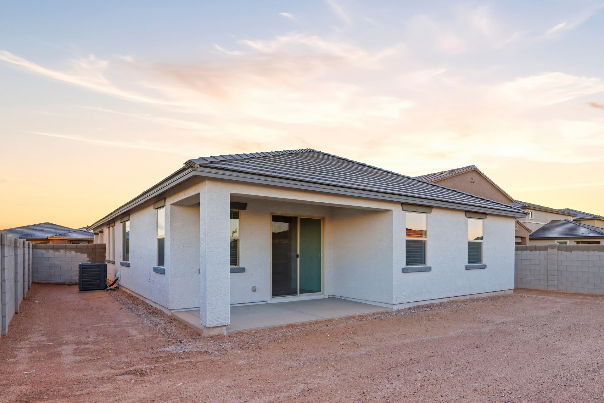 spacious backyard with concrete block wall