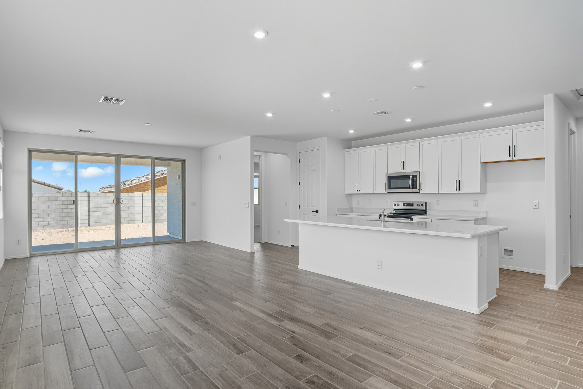 open-concept space with wood-like flooring and recessed lights