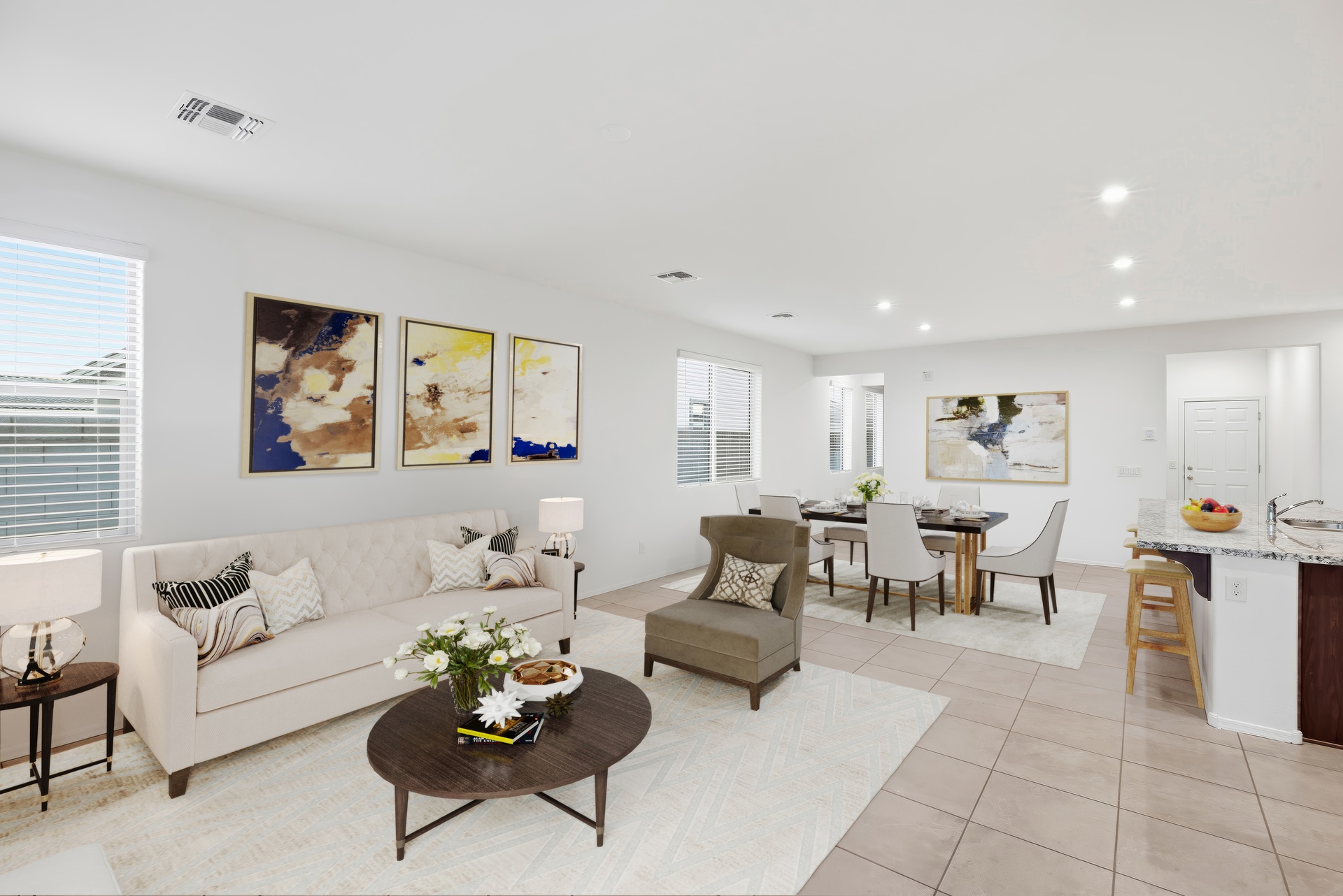 open-concept space with a large white couch and wooden coffee table