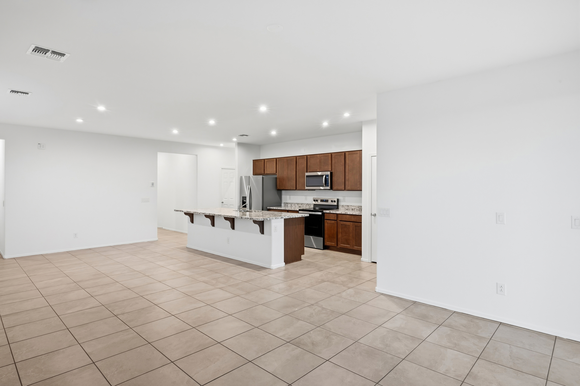 open-concept space with tile flooring and recessed lights