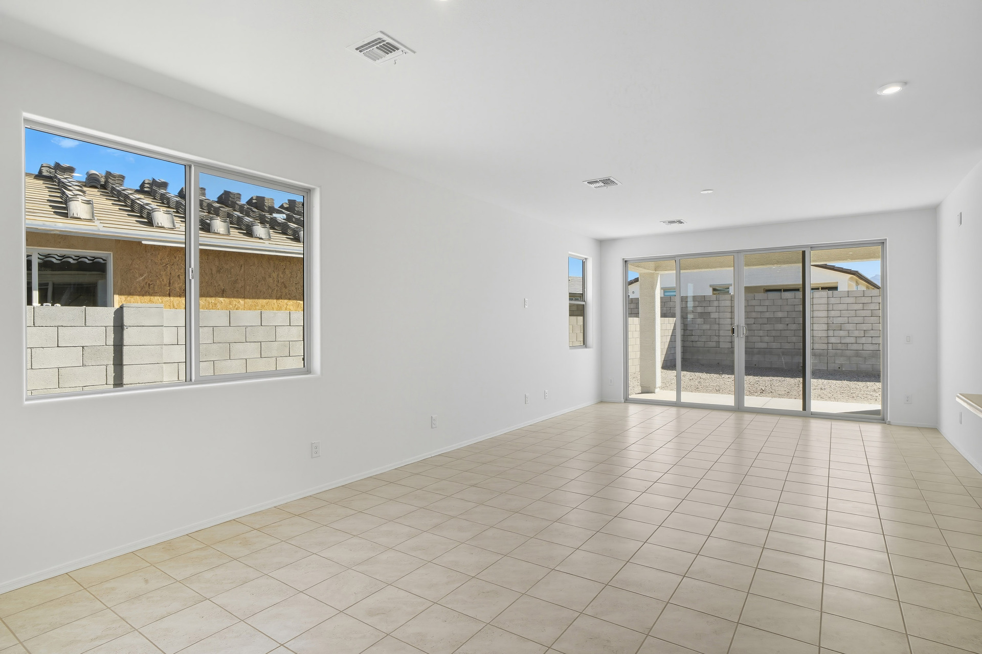 open-concept space with wood-like flooring, recessed lights, and upgraded 12ft sliding glass door