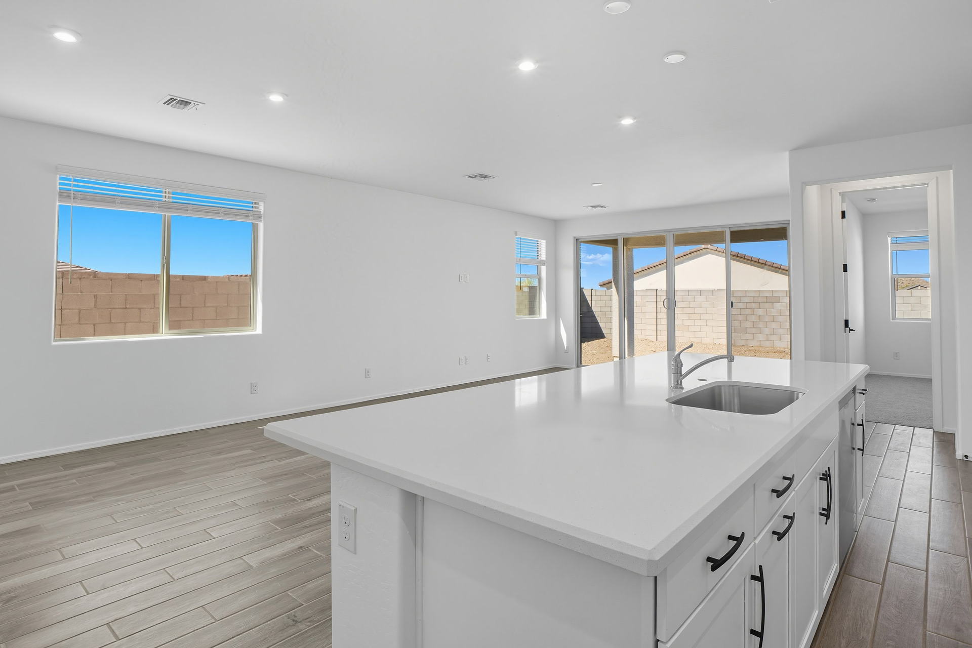 kitchen with quartz countertops, wood-like flooring, and stainless-steel appliances