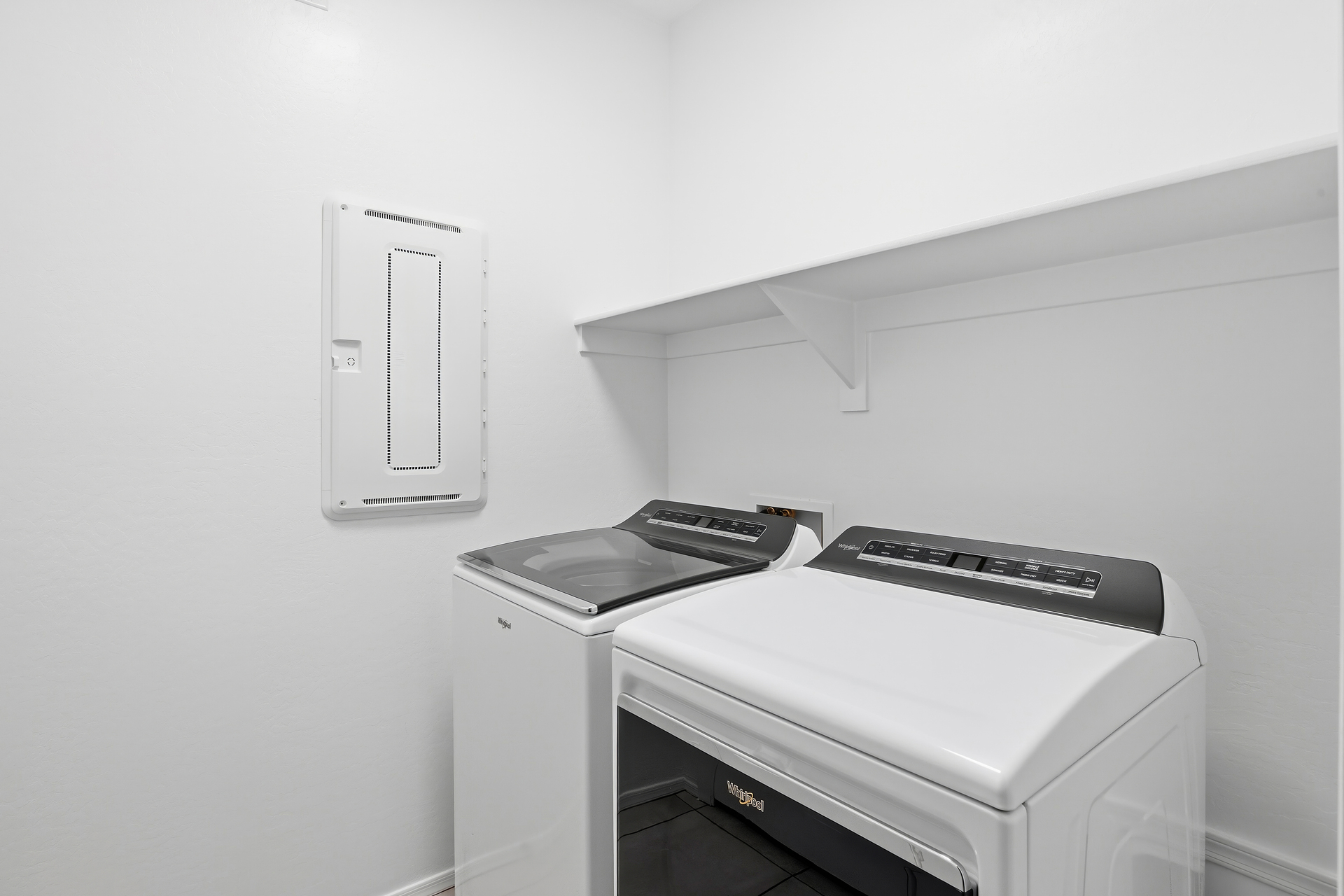 laundry room with whirlpool washer and dryer