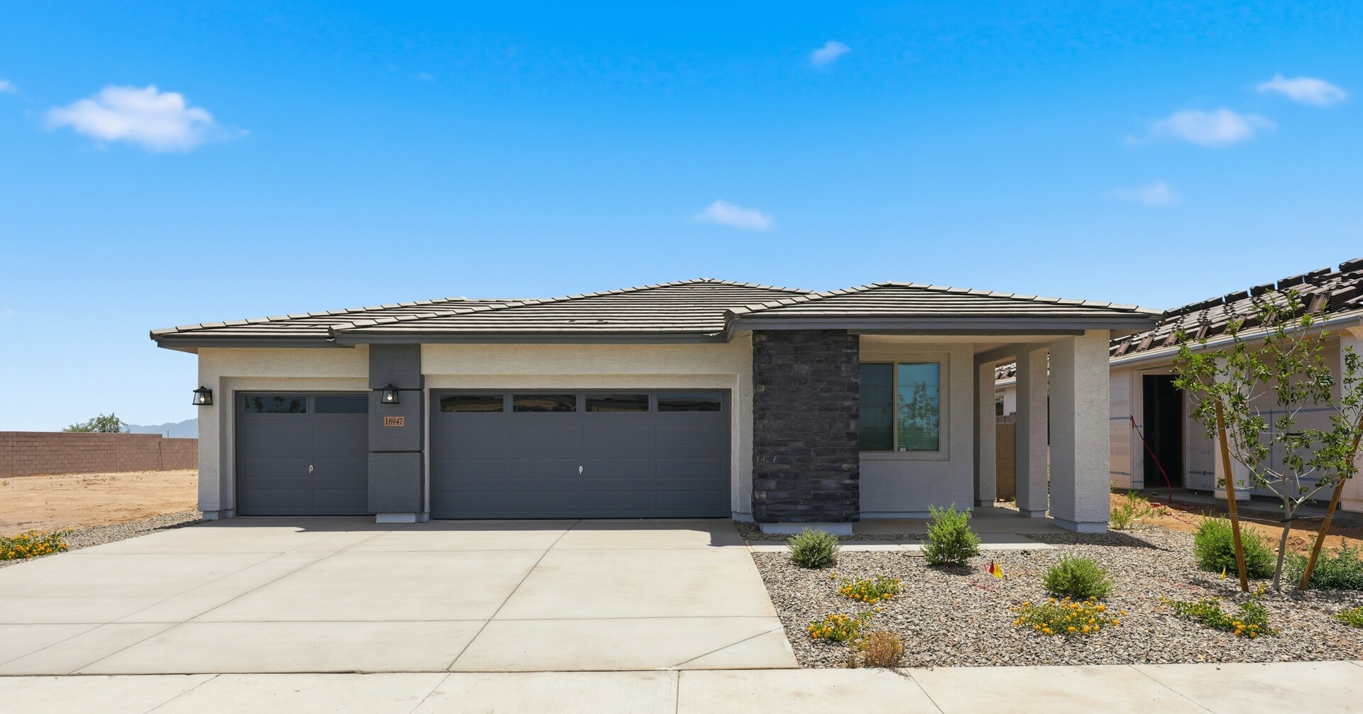 single-family single-story home with desert landscaping, and concrete driveway