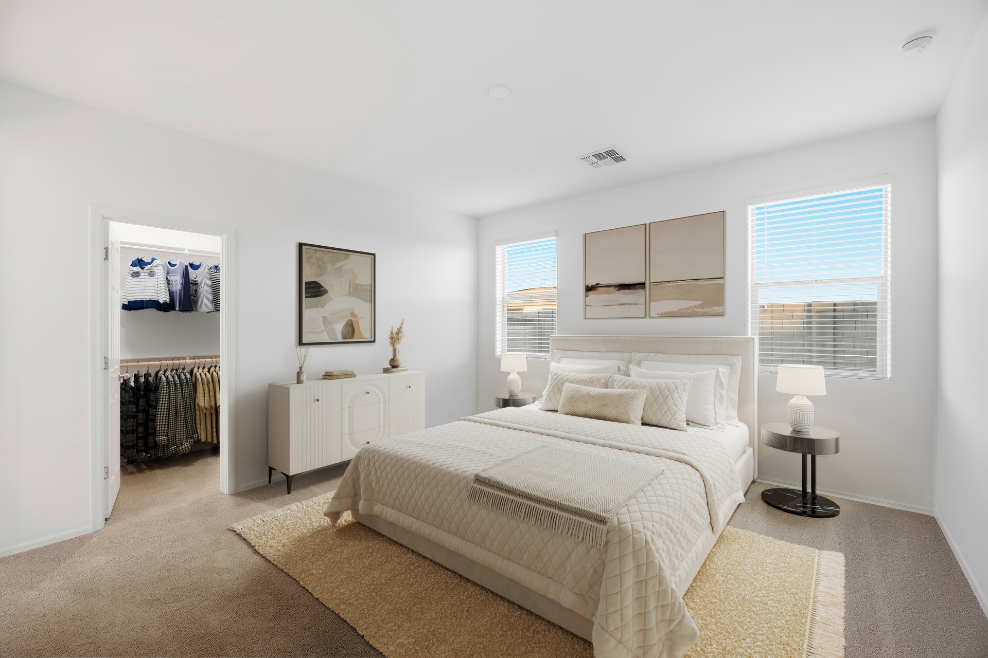 spacious room with large white bed and white dresser