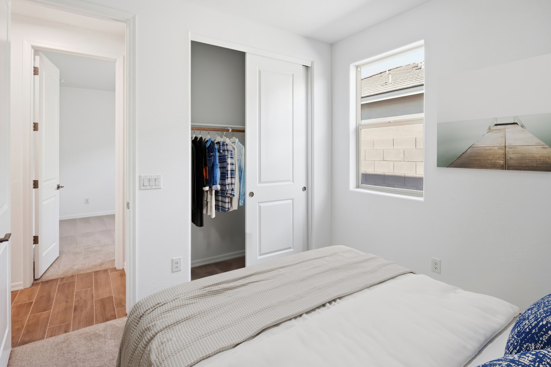 bedroom with a large white bed and blue pillows