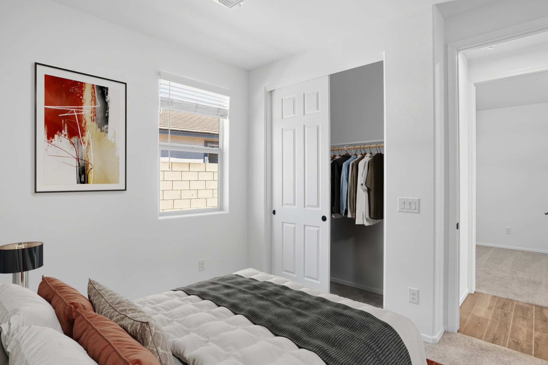bedroom with a large bed and artwork on the wall