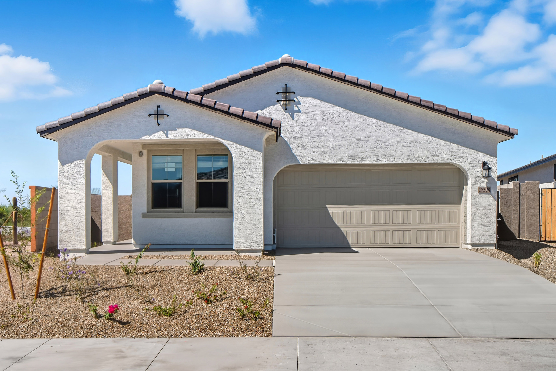 single-story home with desert landscaping and concrete driveway