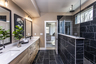 primary bathroom with wood-finish cabinets and tile flooring