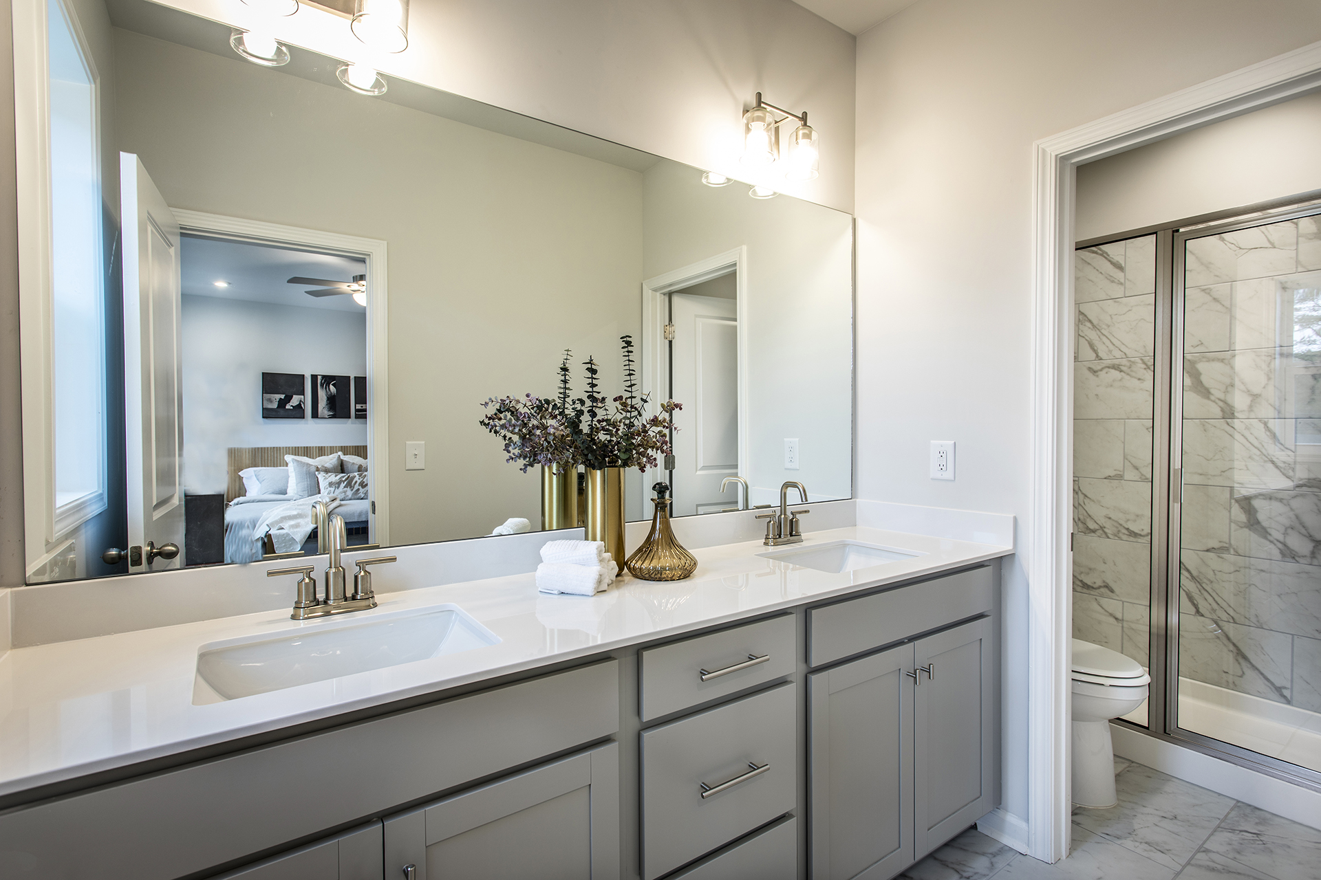 primary bathroom with gray cabinets and tile flooring