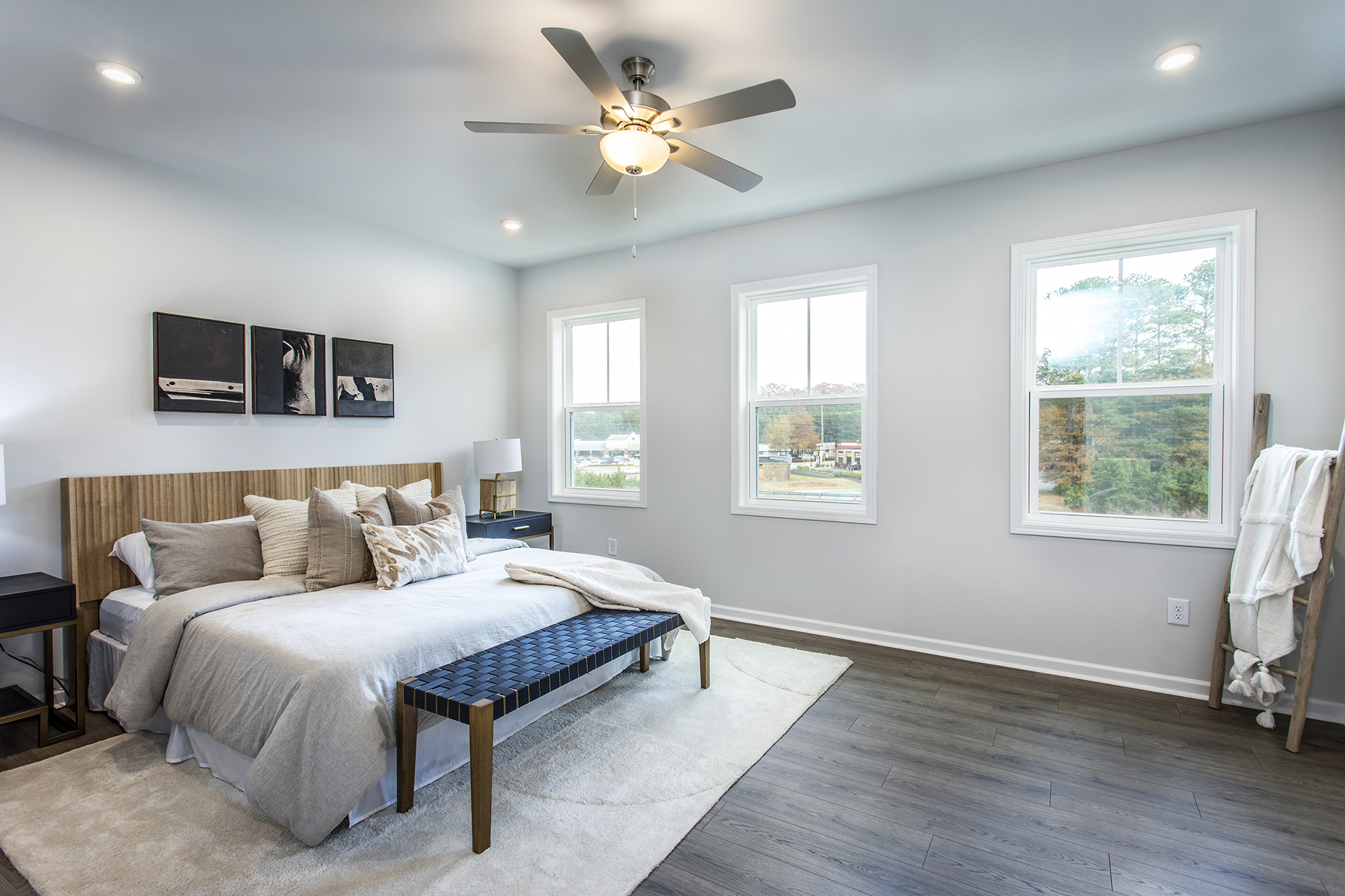 primary bedroom with windows and hard surface floors