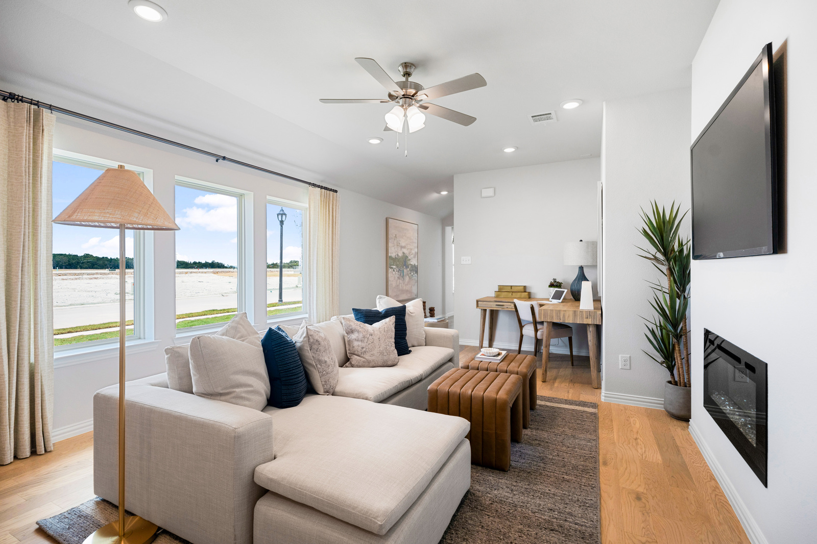 open great room with wood floors and fireplace