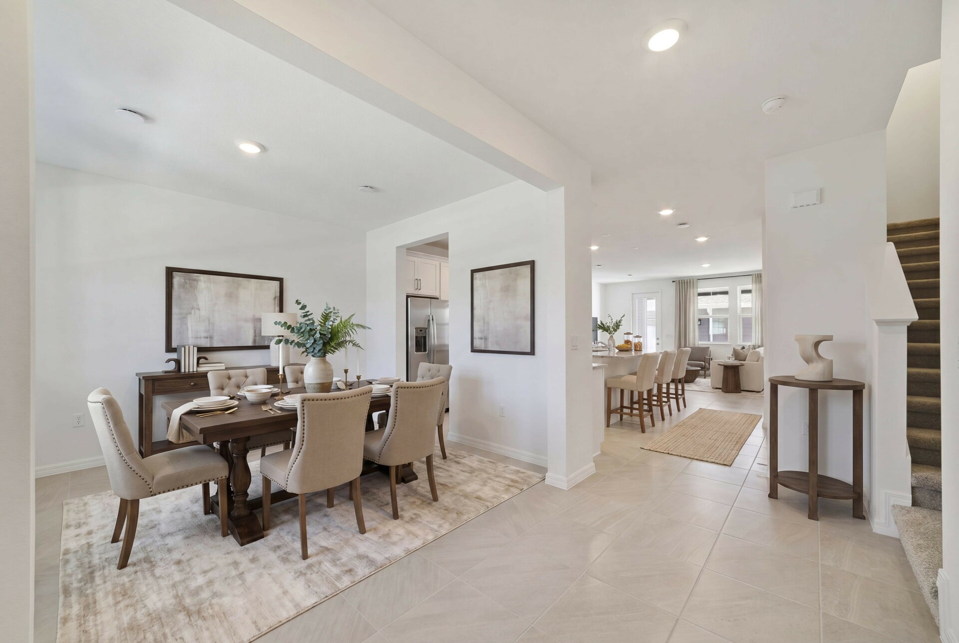 living room and foyer with access to stairs and the kitchen