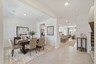living room and foyer with access to stairs and the kitchen