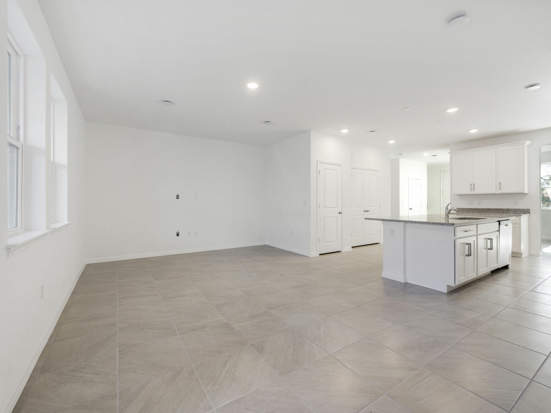 room with view of kitchen and access to the lanai