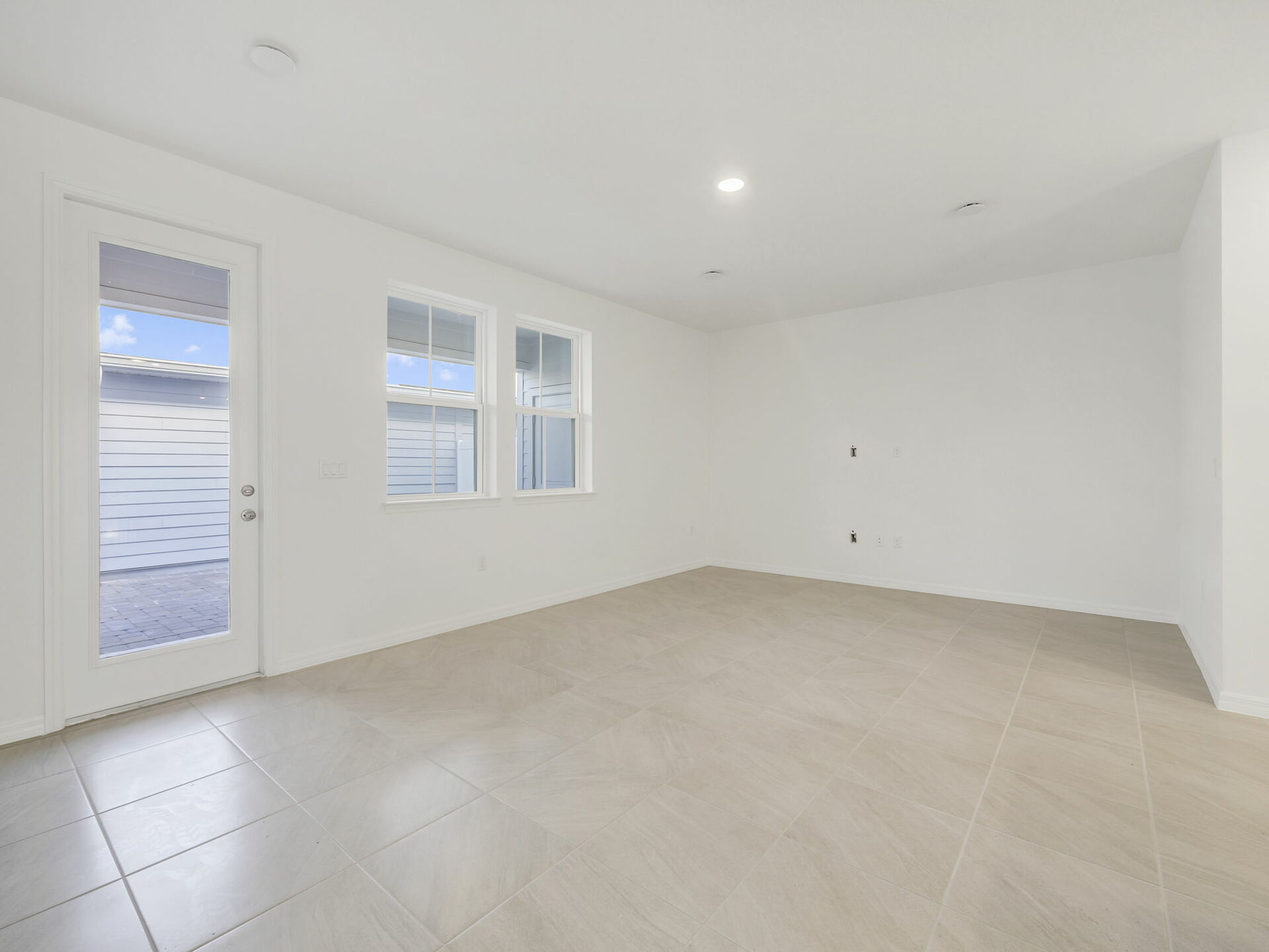 room with view of kitchen and access to the lanai