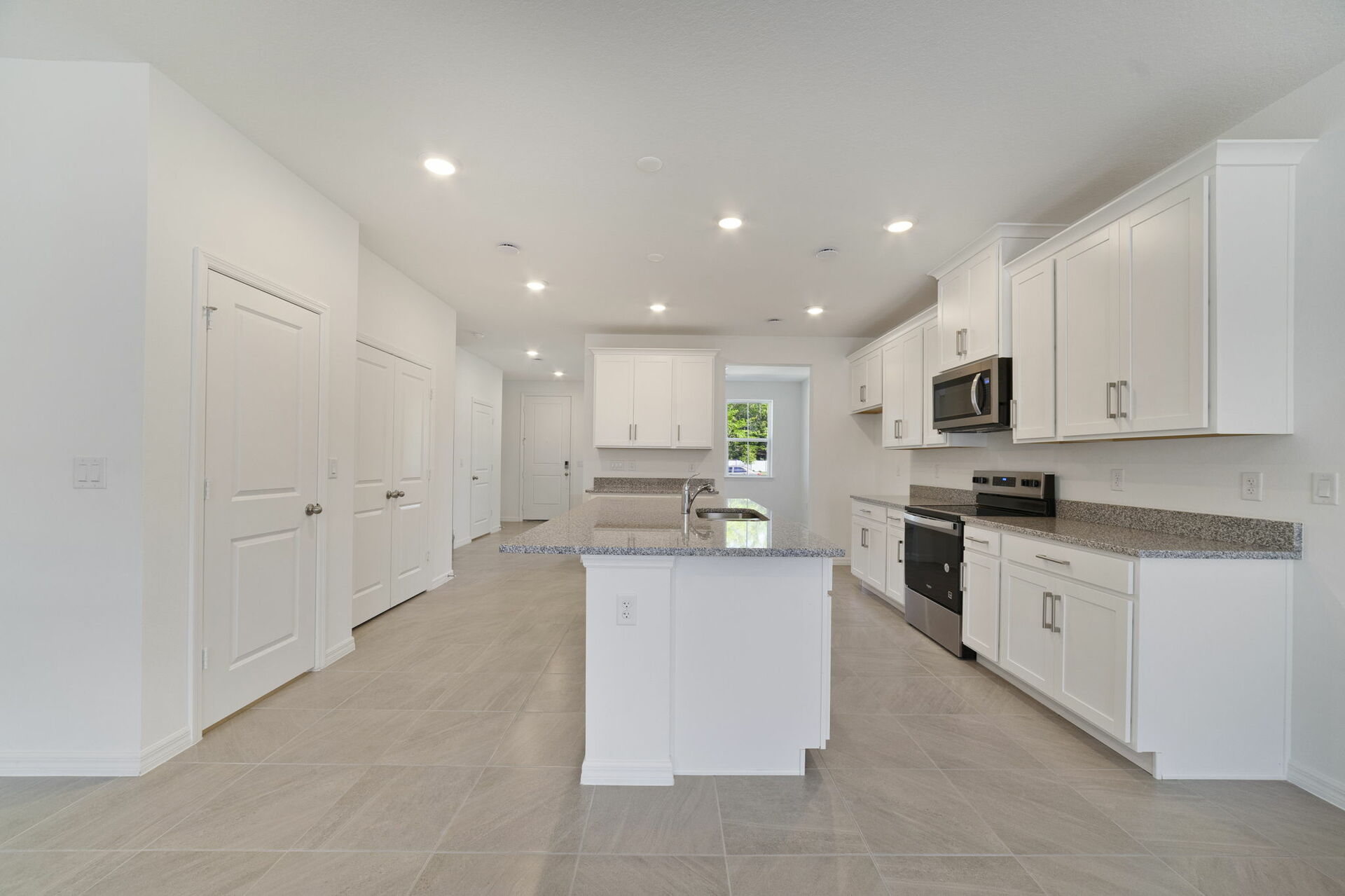 granite center island and stainless-steel appliances  