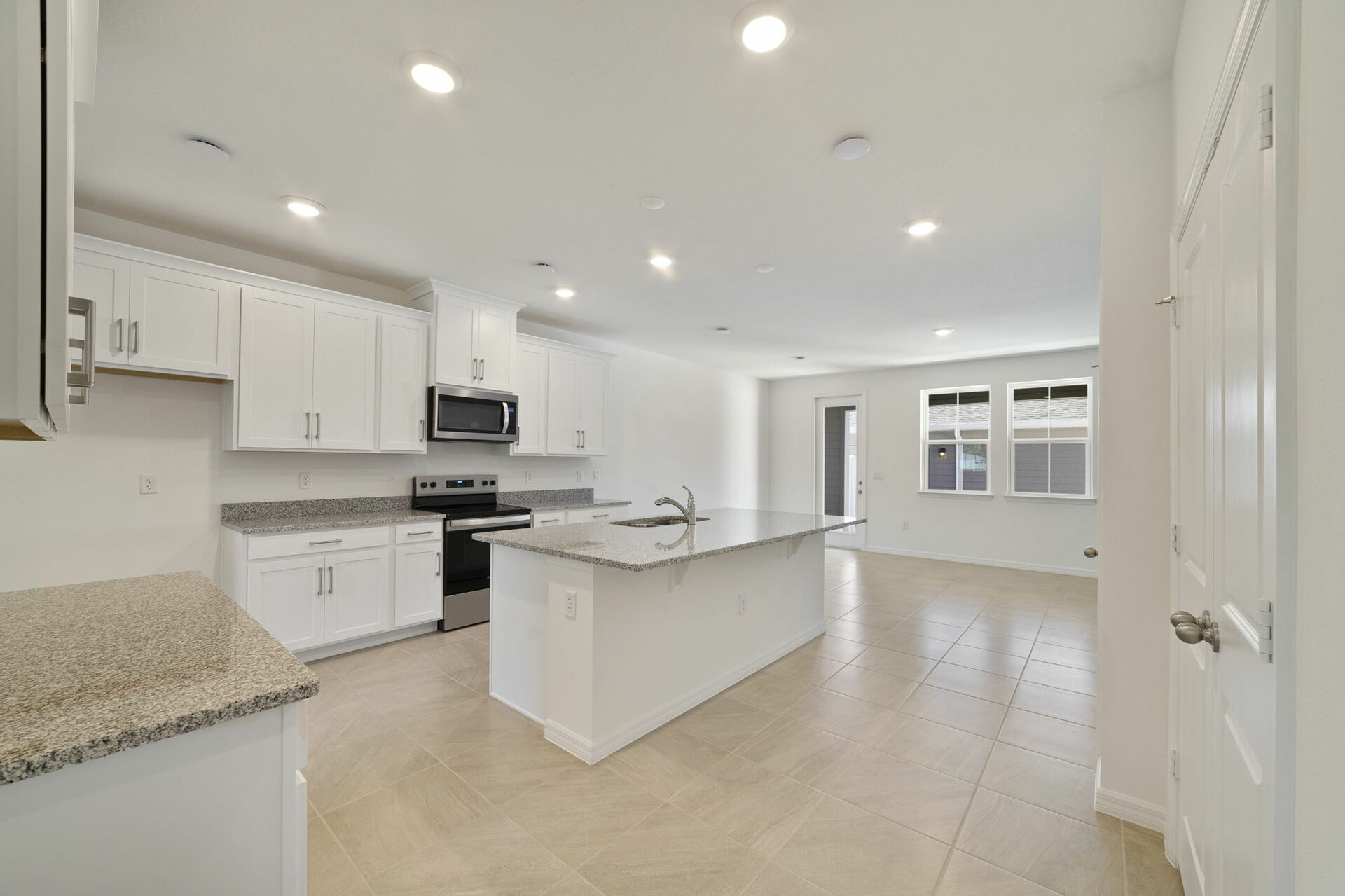 granite center island and stainless-steel appliances  