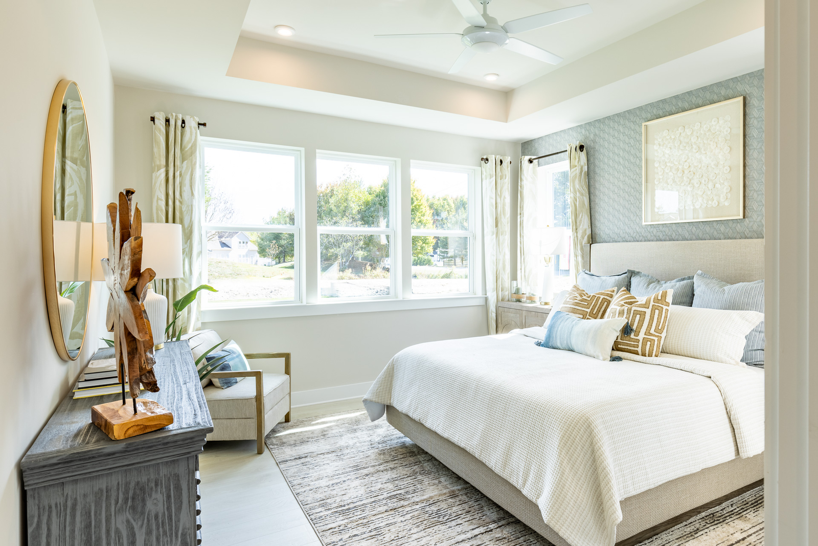 primary suite with a box ceiling and king sized bed