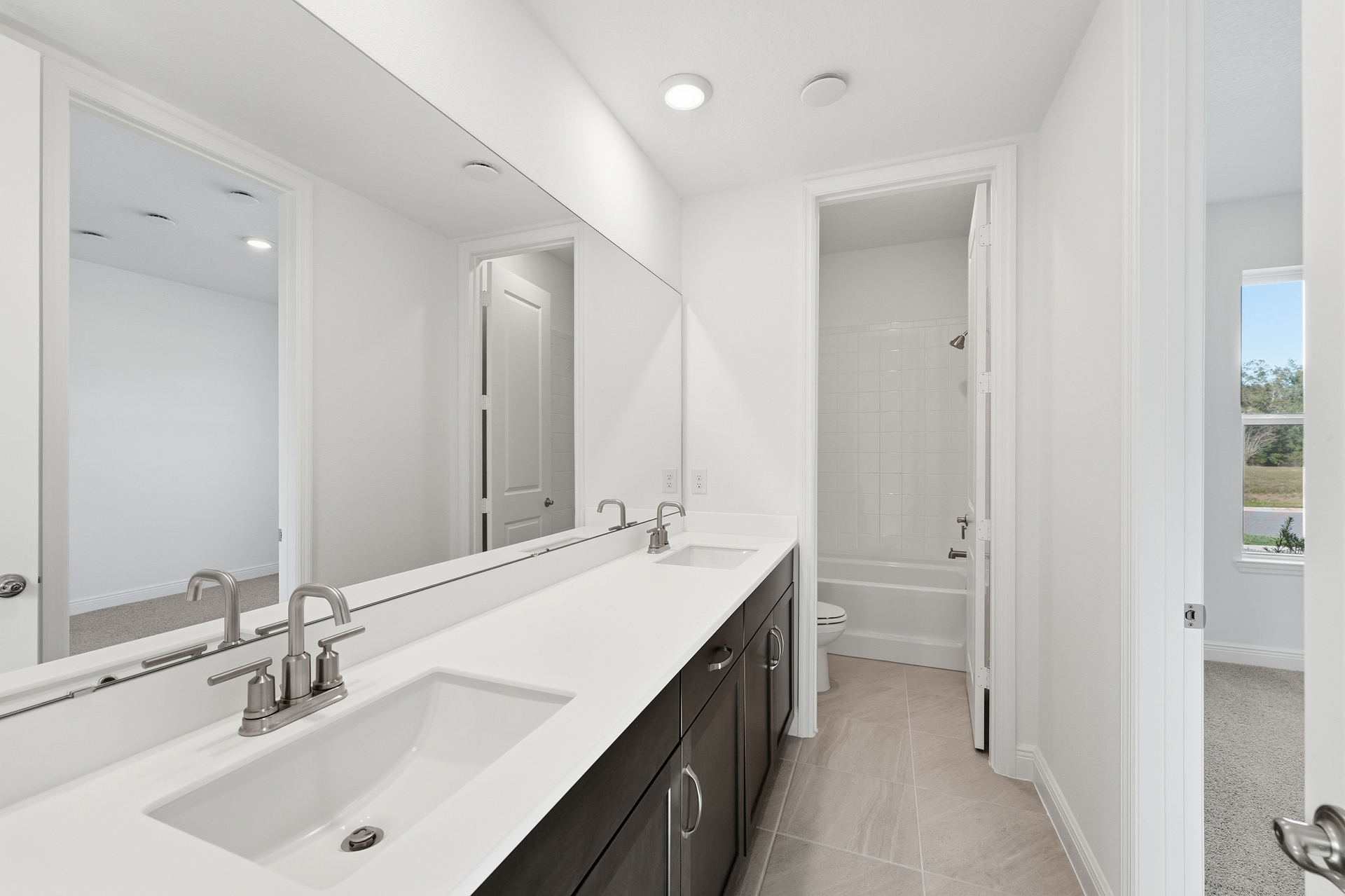 dual sink vanity, water closet and shower