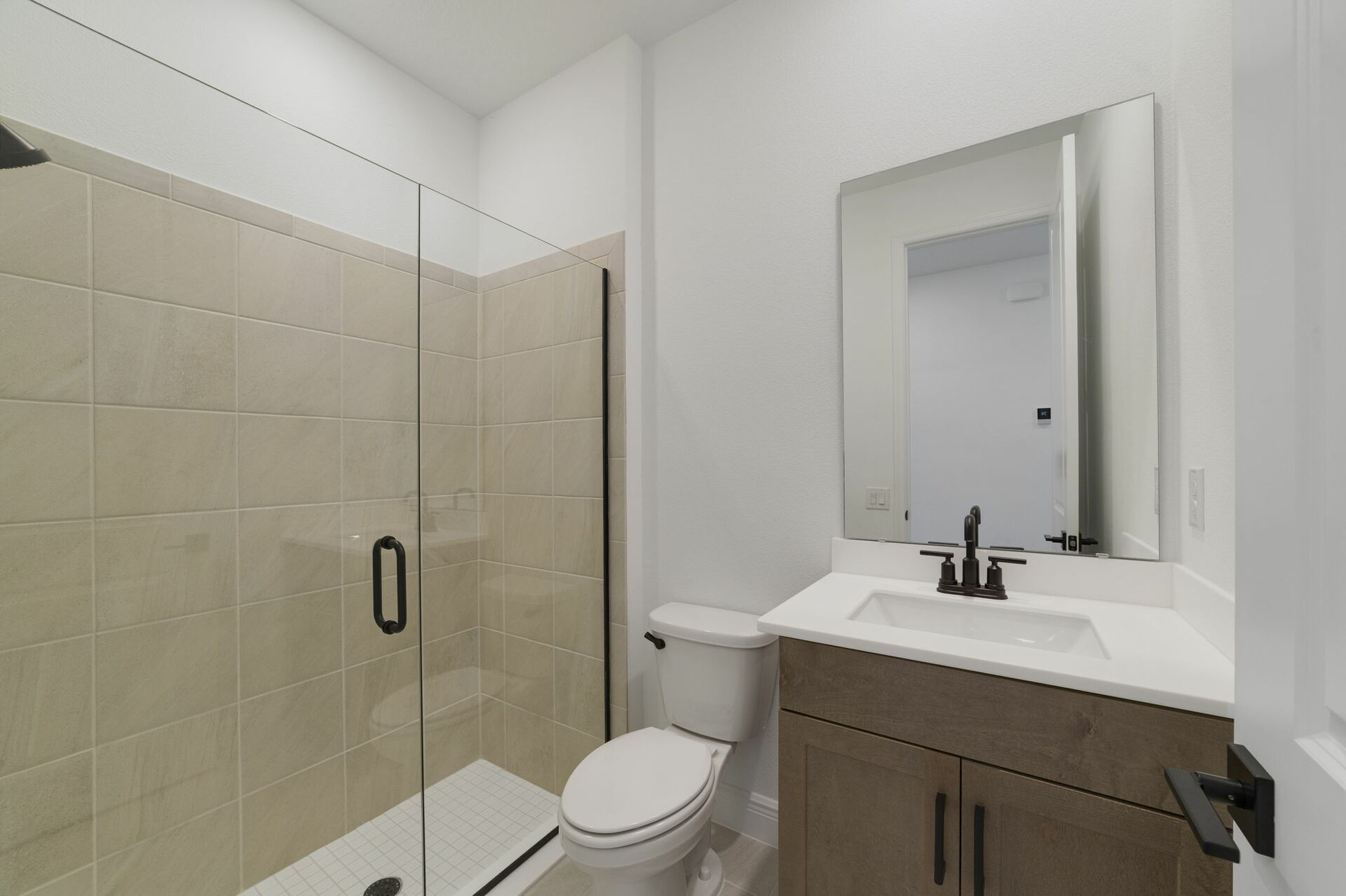 single sink vanity, shower, and water closet