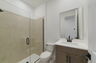 single sink vanity, shower, and water closet