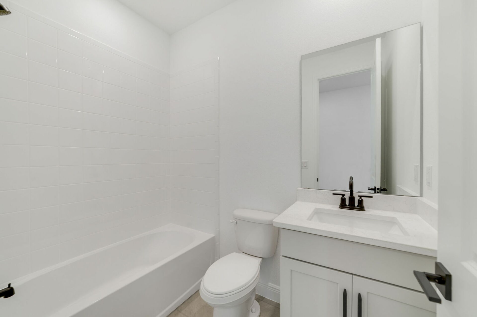 single sink vanity, mirror, water closet and shower