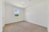 second bedroom with carpet and one window