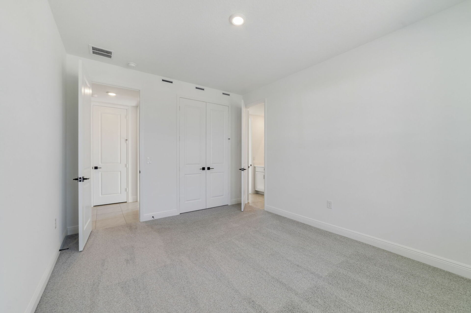 bedroom with carpet and large windows 