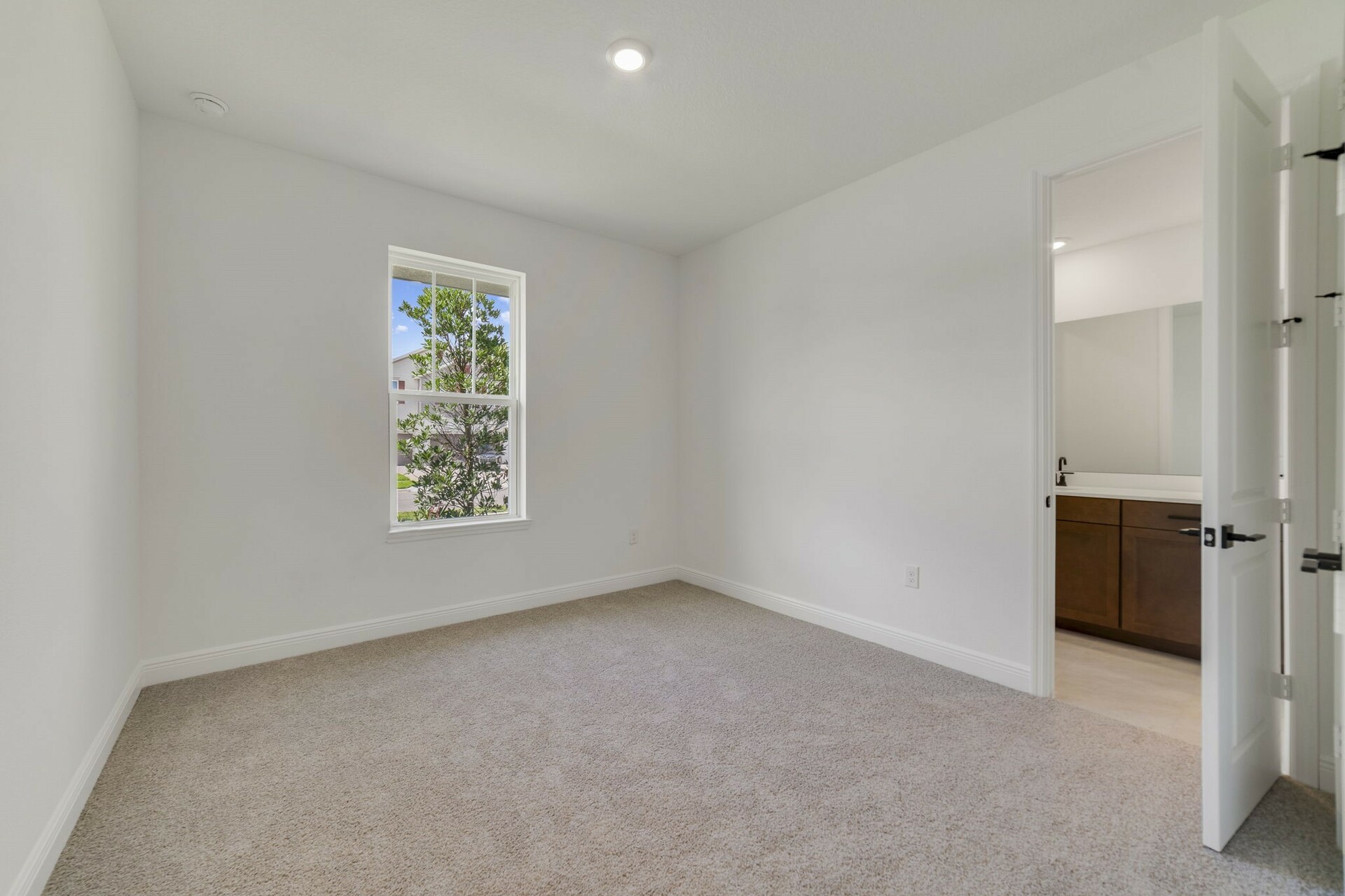third bedroom with carpet and one window