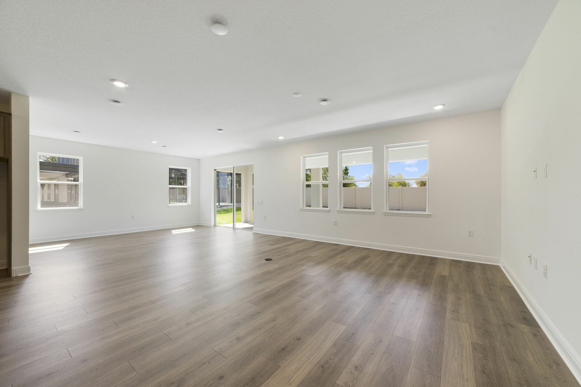 room with access to covered lanai and kitchen