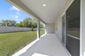covered patio and backyard