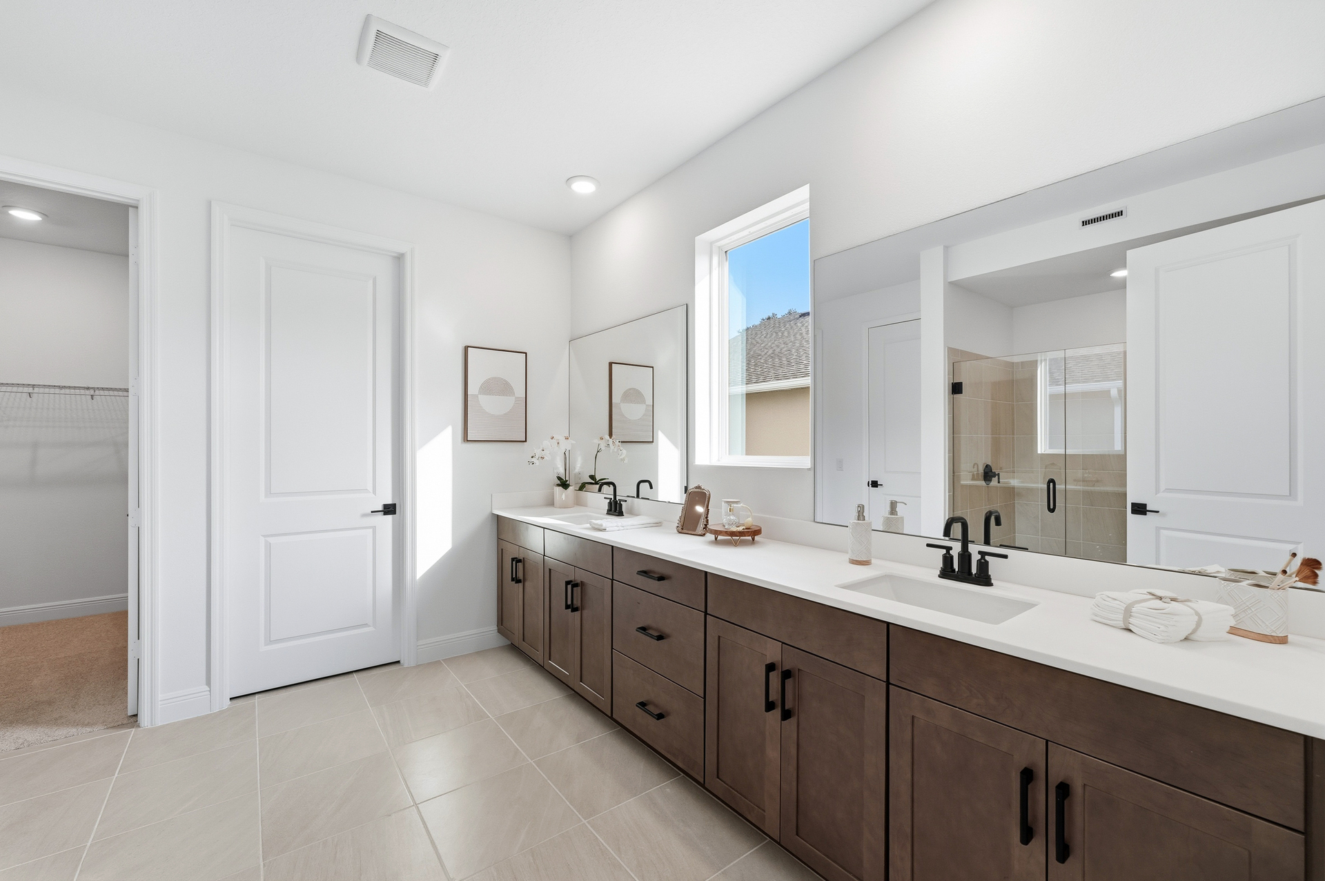 dual sink vanity with shower and primary closet