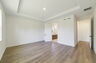 tray ceilings and hardwood vinyl plank with multiple windows. 